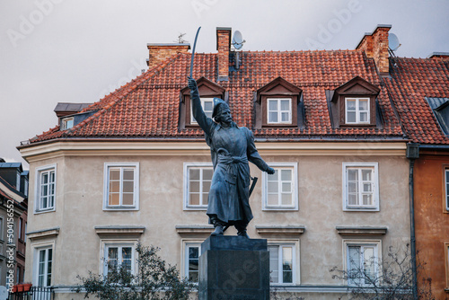 Warsaw, Poland, 13 October 2021: picturesque street with colorful buildings in historic center in medieval city, renaissance and baroque historical buildings at old town, Jan Kilinski Monument