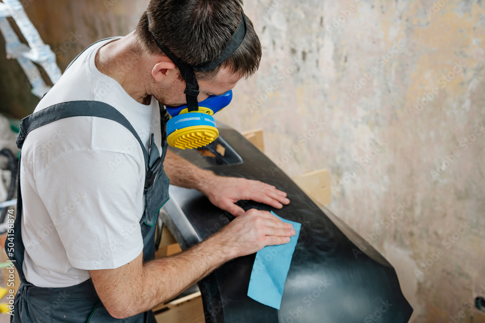 Close up of worker sanding with sandpaper