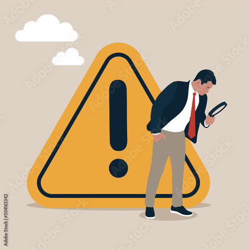 Businessman with magnifying monitor and investigate incident with exclamation attention sign. Incident management, root cause analysis or solving problem, identify risk or critical failure concept.