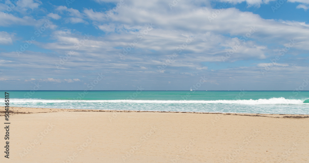 empty summer beach with yacht on horizon empty summer beach with yacht on horizon