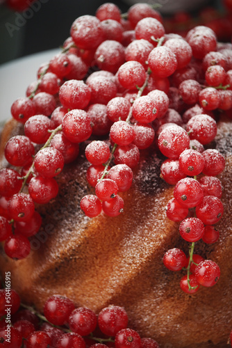A cake with fresh red currant and tea