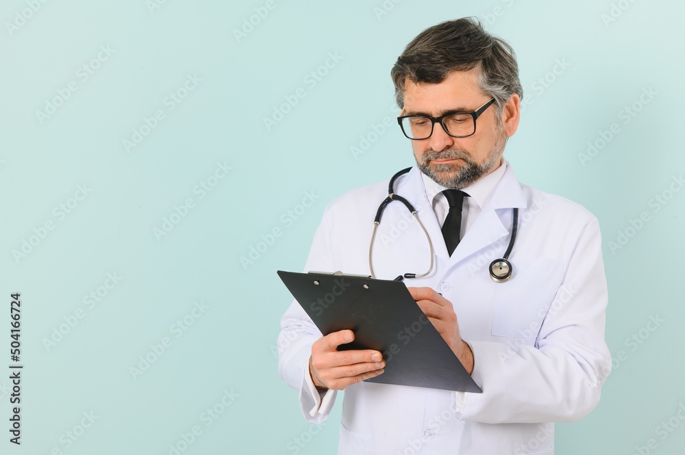 Professional Doctor Man In White Uniform Posing on Blue Studio Background. Panorama With Copy Space. Professional Doctor Man In White Uniform Posing on Blue Studio Background. Panorama With Copy Space.
