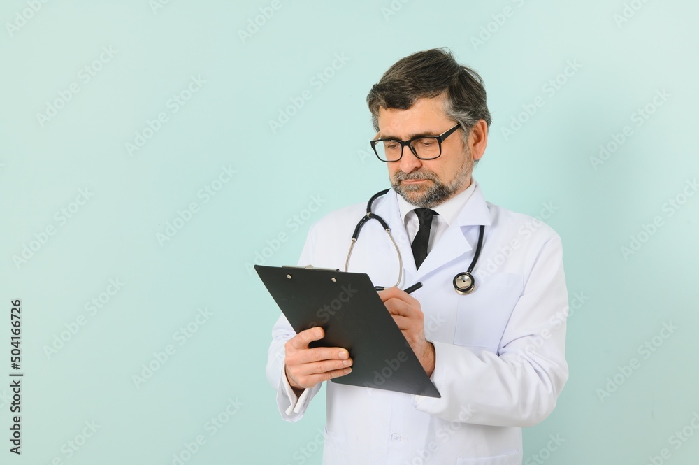 Professional Doctor Man In White Uniform Posing on Blue Studio Background. Panorama With Copy Space. Professional Doctor Man In White Uniform Posing on Blue Studio Background. Panorama With Copy Space.