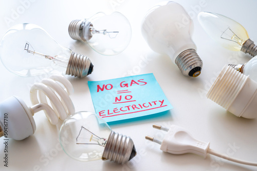 Light bulbs, electric plug and blue ticket with the text "no gas, no electricity". Energy dependence on gas and Russian gas.