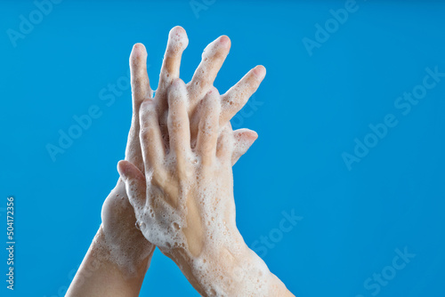 Woman rubbing fingers on blue background