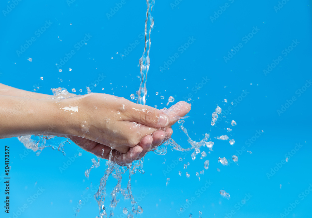 Fototapeta premium Washing hands with water on blue background