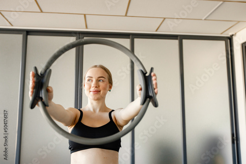 Portrait of a woman doing excercises with a special equipment