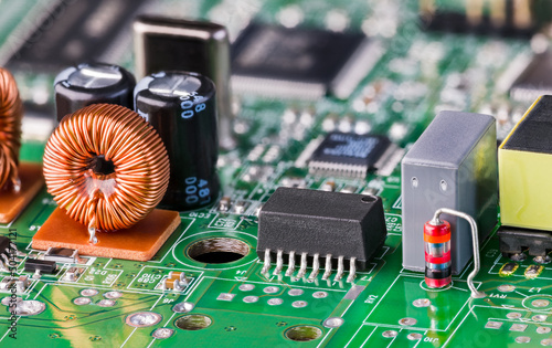 Принти на полотні Coil or varied electronic components on green printed circuit board detail