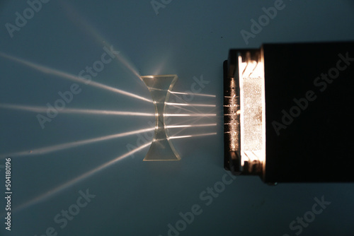 Parallel beams from the light box are refracted through a concave lens. Optical physics experiment. photo
