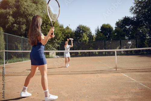 Two female tennis players on a tennis court during the match © prostooleh