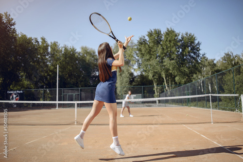 Caucasian female tennis player playing on the court outdoors © prostooleh