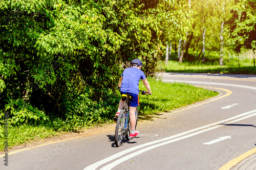 Wallpaper Mural Cyclist ride on the bike path in the city Park
 Torontodigital.ca