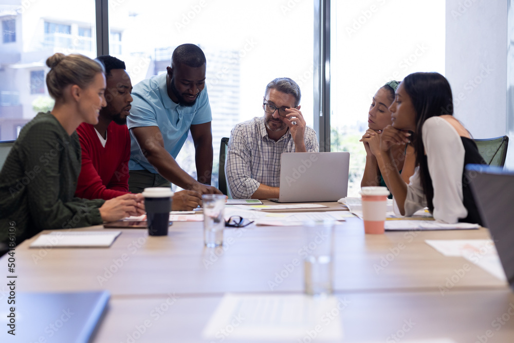 Fototapeta premium Multiracial businessmen and businesswomen discussing strategy during meeting in boardroom at office