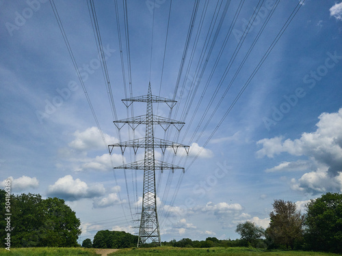 Electric transmission line with high voltage pylon in Witten Germany, blue sky, contrast, no people