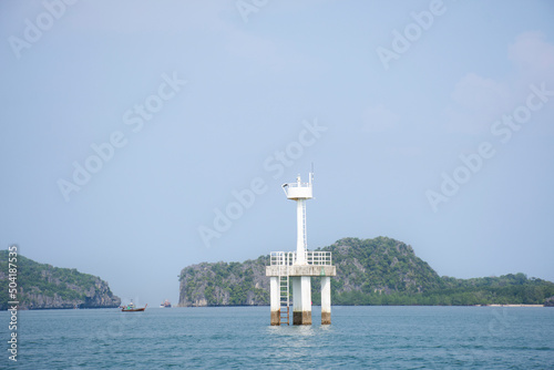 Classic vintage lighthouse or beacon in sea ocean for security protection of fishing boat and fishery ship sailing at Mu Ko Petra National Park in Pak Bara waterfront at La ngu city in Satun, Thailand © tuayai