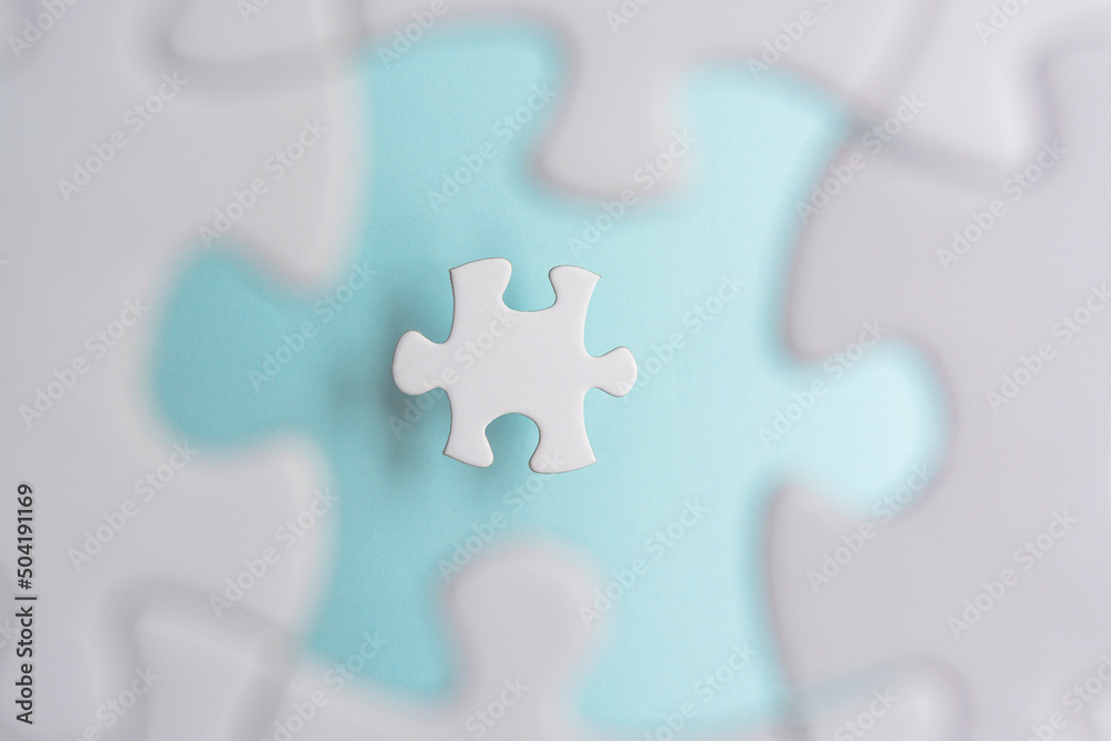 Obraz premium Puzzle pieces isolated on blurred blue background. Flat lay. Directly above.