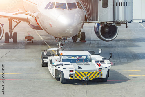 Photos Towing truck pushing back ready to tow the plane jet to the parking place at the airport
