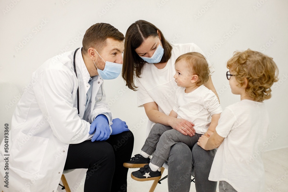 Mother and two her sons have an appointment with pediatrician Mother and two her sons have an appointment with pediatrician