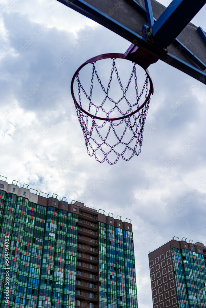 Basketball hoop on the background of clouds