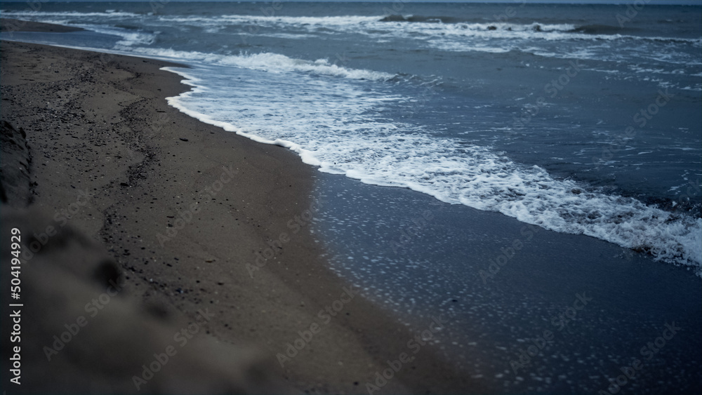 Beach waves crashing sand shoreline landscape. Blue ocean splashing coast nature