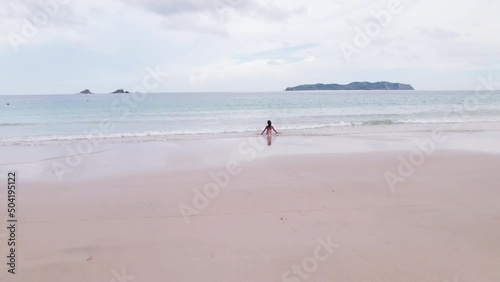 Drone Ofwoman Sitting In Sea On Nacpan Beach photo