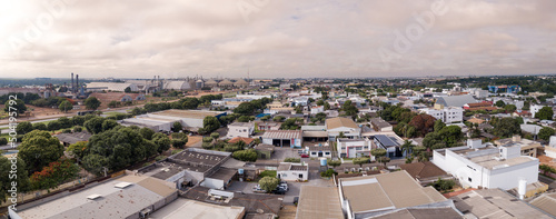 Drone aerial view of Sorriso city skyline, buildings, houses and BR 163 road on cloudy summer day, Amazon, Mato Grosso, Brazil. Concept of cityscape, landmark, architecture, logistics, transport. photo