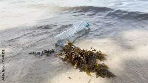 Plastic Bottle Washed Ashore, Highlighting Environmental Pollution