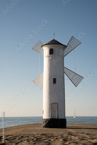 Old lighthouse in Swinoujscie, a port in Poland on the Baltic Sea. The lighthouse was designed as a traditional windmill. Panoramic image. old mill. lighthouse