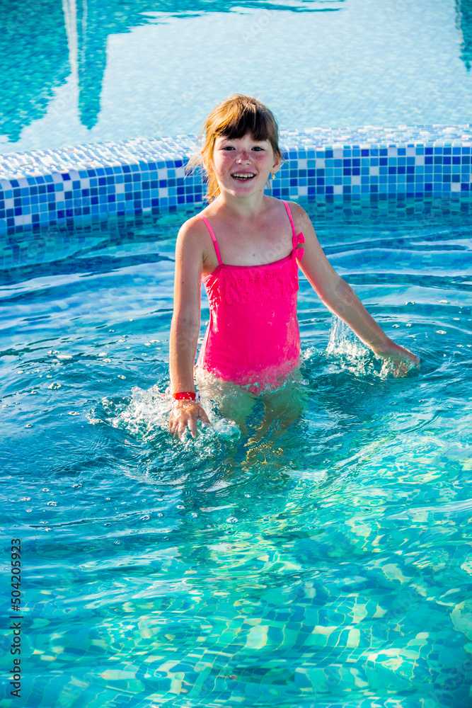 little girl in blue swimming pool