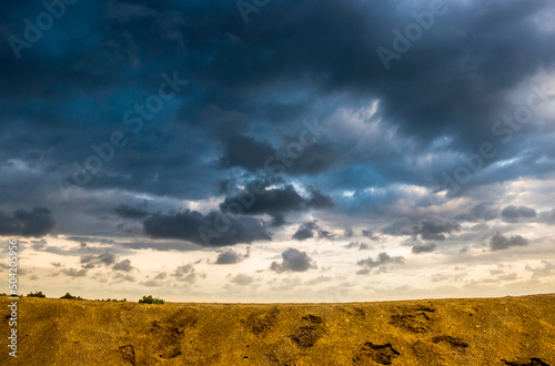 cloudy sky under the sand of sea beach, Arabat Spit, Ukraine photo