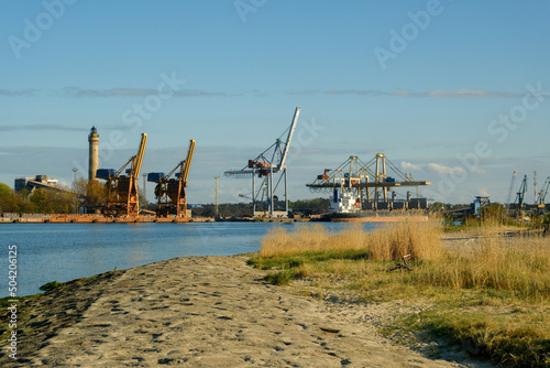 industrial area on the coast. big cranes in the background. port