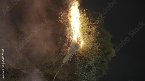 Bamboo Pyre being lit on fire at Hachiman Matsuri event in Omihachiman, Japan photo