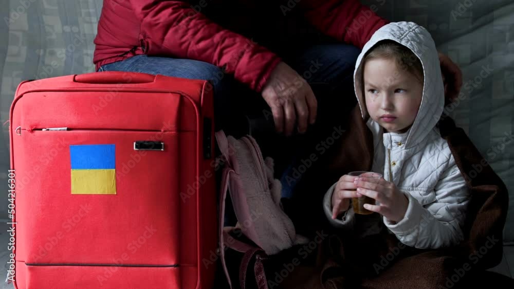 Refugees from Ukraine. An old man and his granddaughter are waiting for help at the resettlement center. War of Russia against Ukraine. Refugees from Ukraine. An old man and his granddaughter are waiting for help at the resettlement center. War of Russia against Ukraine.