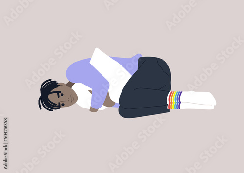 A young depressed male African character squeezing a pillow, Homophobia and bullying