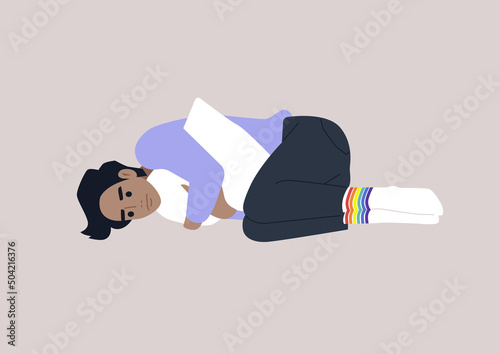 A young depressed male Caucasian character squeezing a pillow, Homophobia and bullying