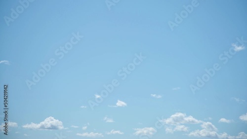 Time lapse of blue sky with tiny clouds moving slowly