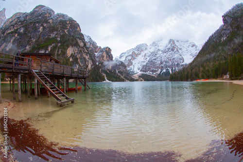 Lake Braies (Lago di Braies) in Dolomites Mountains, Boat hut on Braies Lake with Seekofel mount on background, Sunrise of Italian Alps, Naturepark Fanes-Sennes-Prags, Dolomite, Italy, Europe. photo