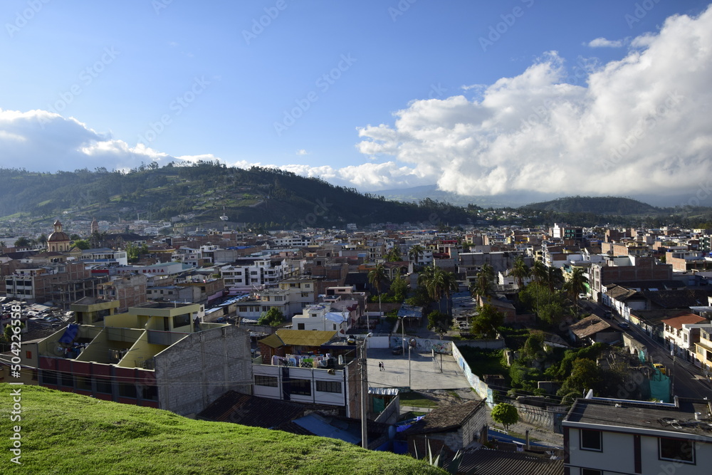 the view from the height of the old town of Otavalo under a cloudy sky.
