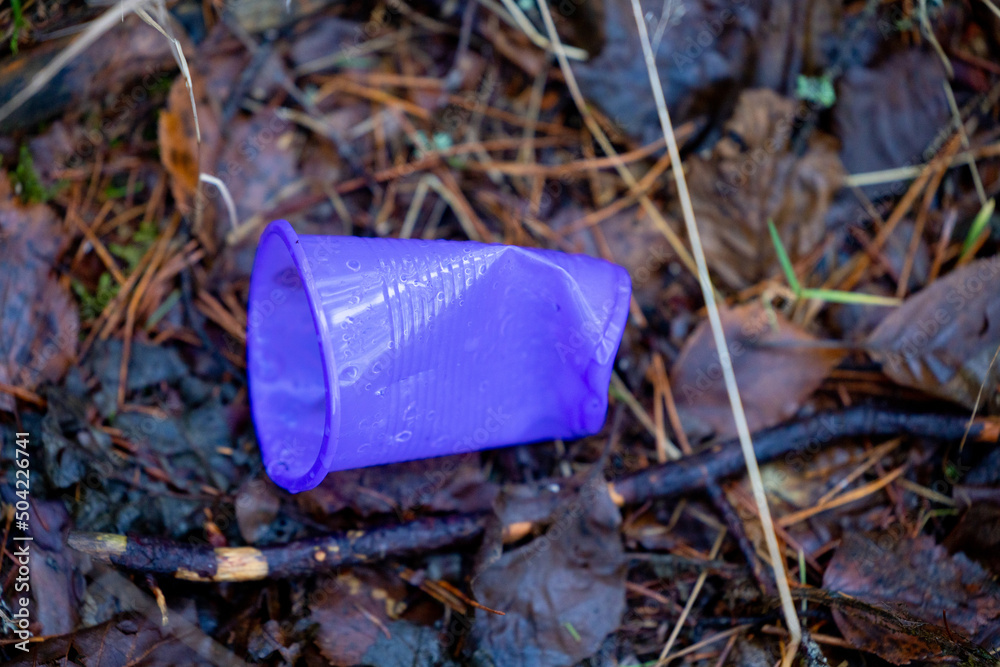Dirty plastic bottle left in the forest. Plastic waste in the environment. Environmental pollution. Non-degradable waste. Environmental problems. Protection of nature and ecology. Unecological Dirty plastic bottle left in the forest. Plastic waste in the environment. Environmental pollution. Non-degradable waste. Environmental problems. Protection of nature and ecology. Unecological