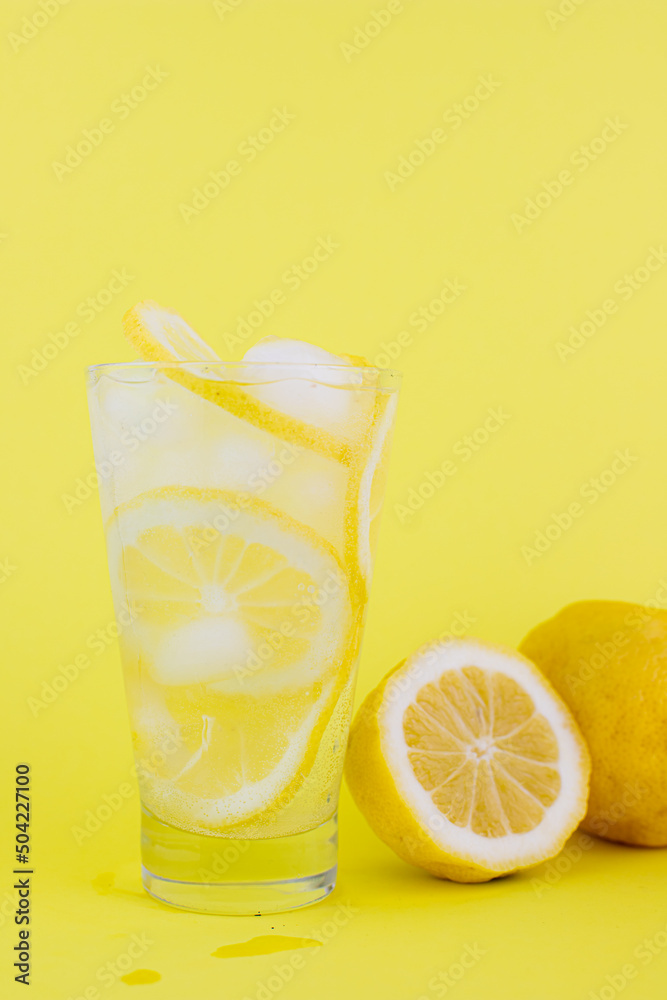 lemonade with lemons and ice on a yellow background lemonade with lemons and ice on a yellow background