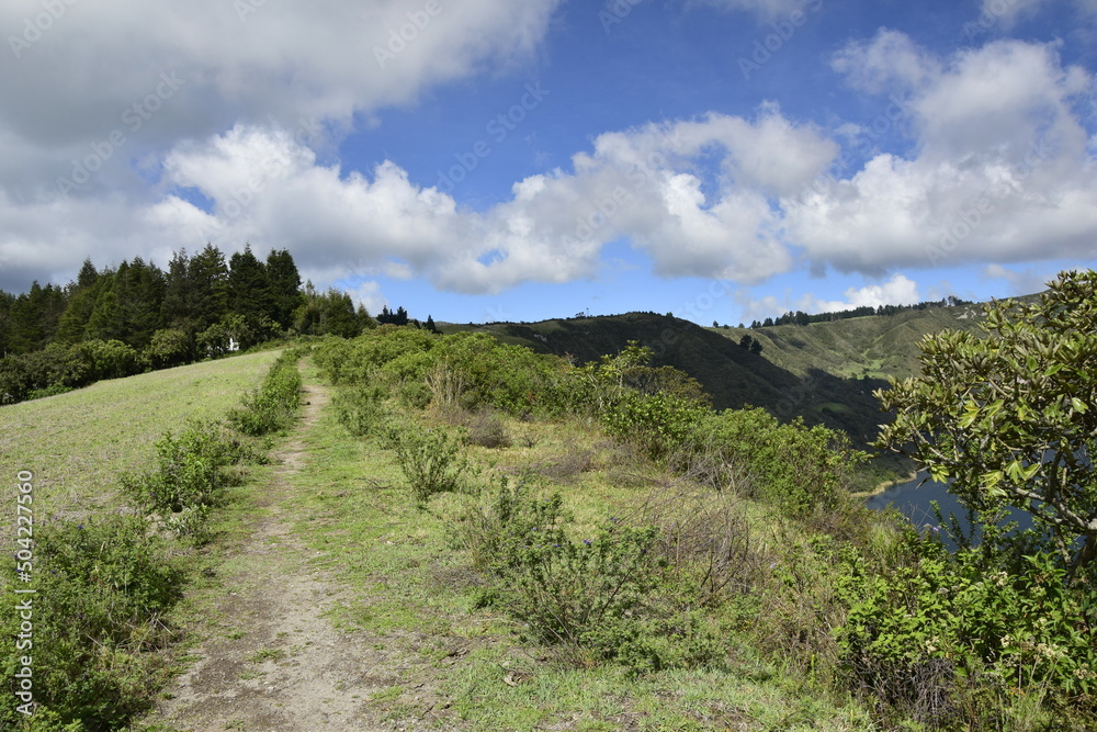 dirt road through the forest around Laguna Cuicocha, beautiful lagoon inside the crater of the Cotacachi volcano. dirt road through the forest around Laguna Cuicocha, beautiful lagoon inside the crater of the Cotacachi volcano.