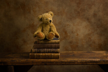 Old teddy bear on wooden shelf