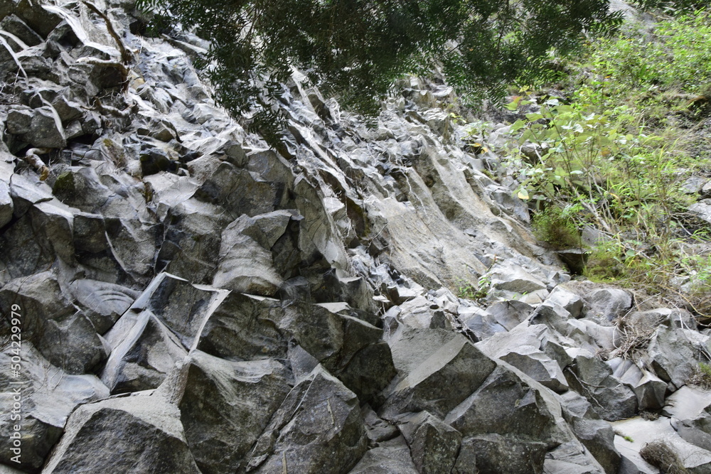 carved rock next to Pailon del Diablo - Mountain river and waterfall in the Andes. Banos carved rock next to Pailon del Diablo - Mountain river and waterfall in the Andes. Banos