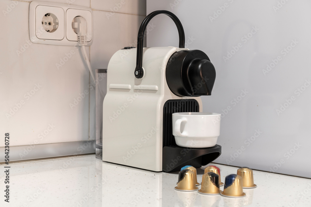 Coffee capsule machine in the corner of a kitchen counter