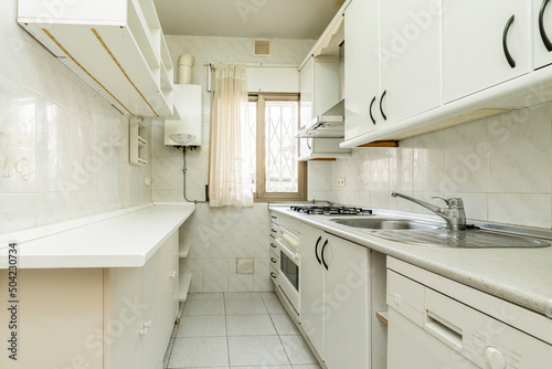 Wallpaper Mural White furniture kitchen with matching countertop, light tiles on walls and floors Torontodigital.ca