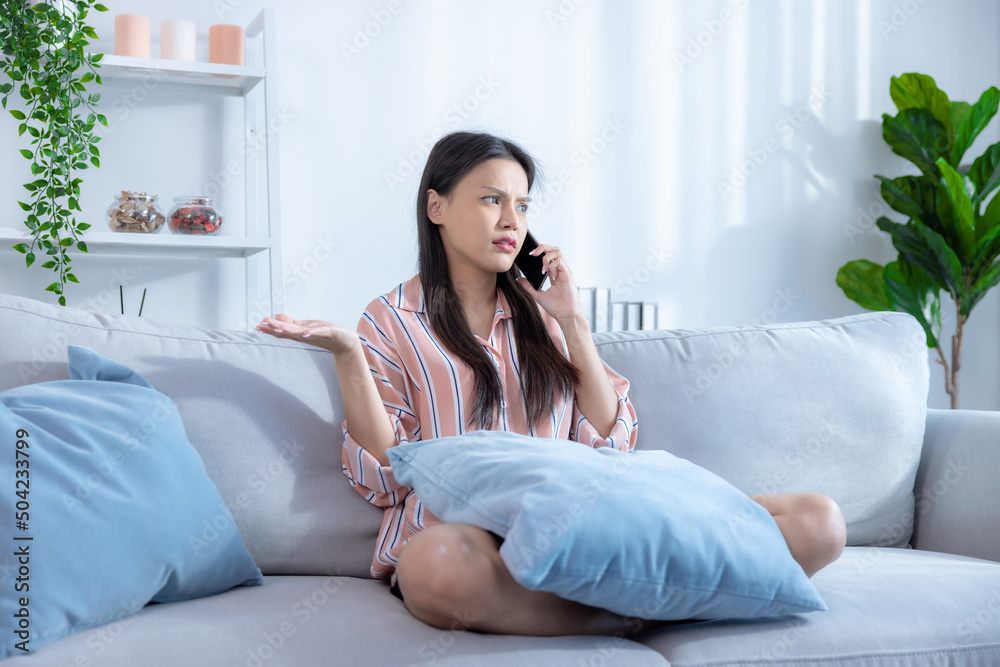Asian woman talking on the mobile phone with stress. Asian woman talking on the mobile phone with stress.
