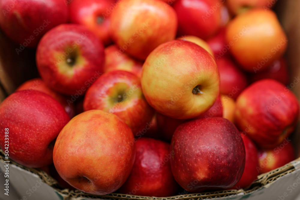 Red apples in the cardboard boxes on the supermarket shelf Red apples in the cardboard boxes on the supermarket shelf