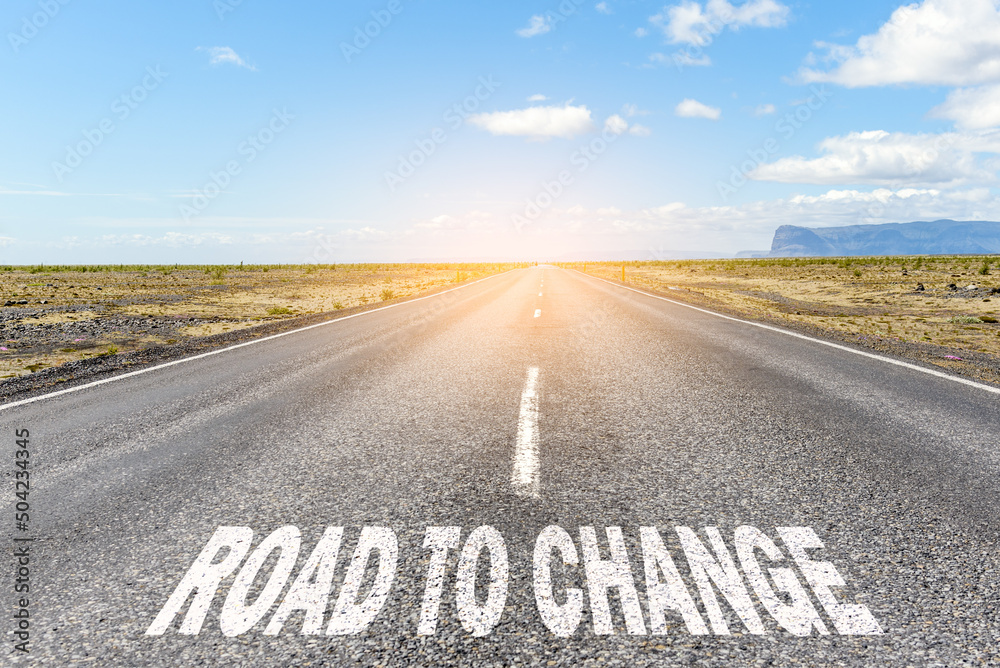 Road to change. Conceptual image of a deserted straight road through a desert landscape with the text 