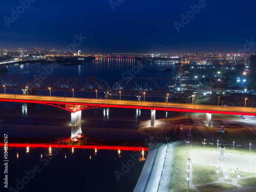 Panorama of the Siberian city of Krasnoyarsk. Night view from above. Bridges over the Yenisei River