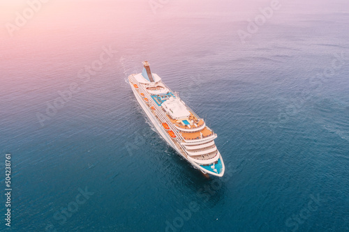 Ship cruise liner sails on the sea, top aerial view.